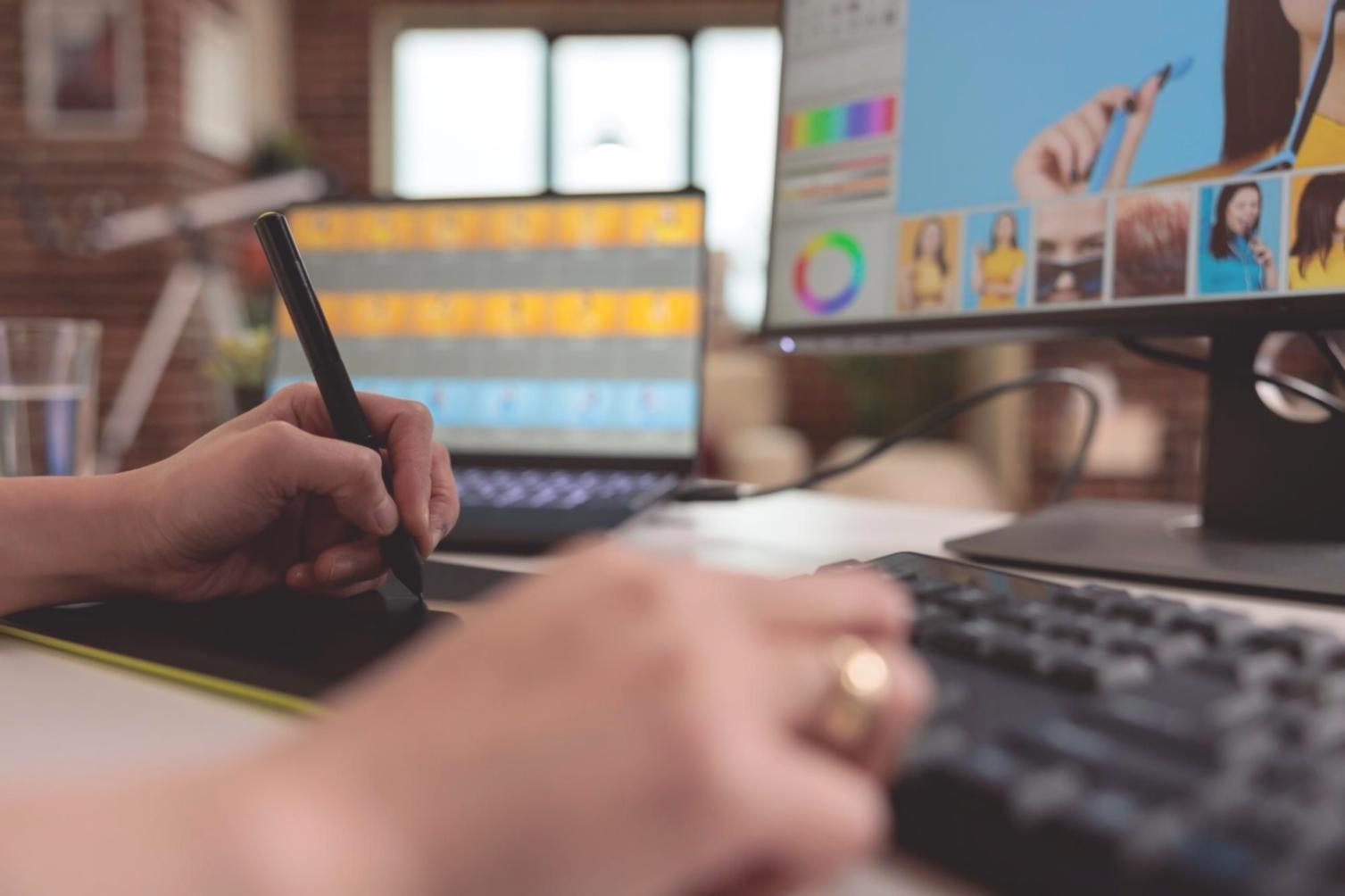Development team meeting with laptops and technical documentation spread across a conference table
