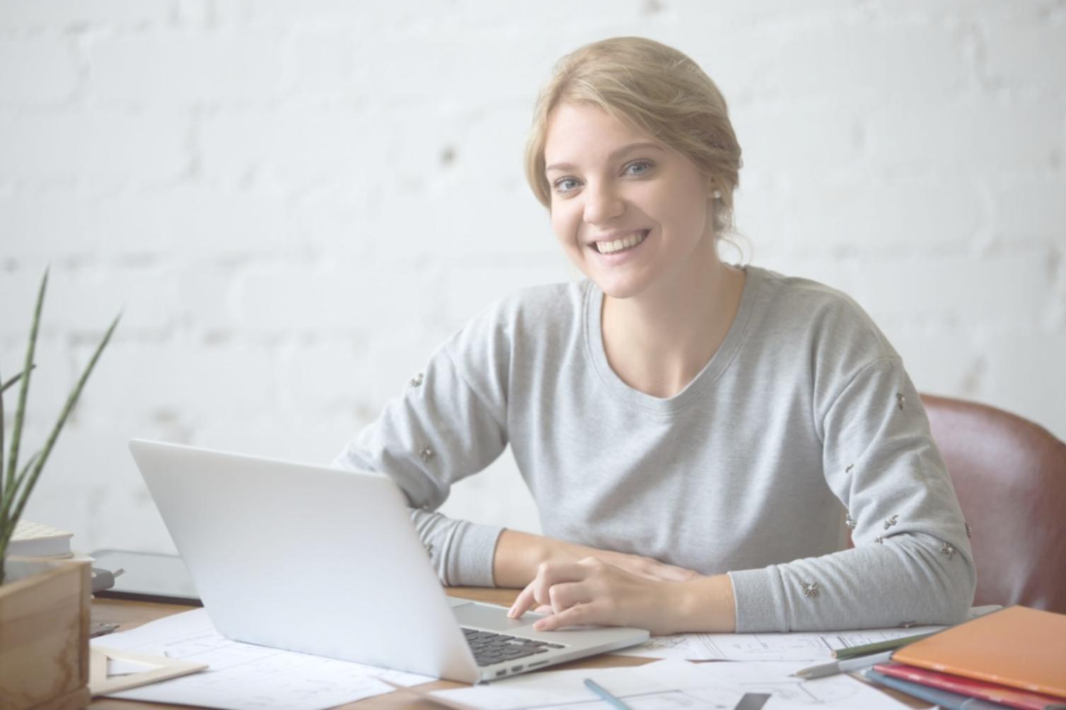 International students collaborating on technical projects with modern laptops and devices